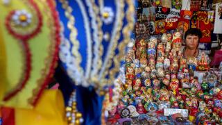Russian Kokoshnik and Matreshka dolls in a range on a counter of a souvenir shop on Red Square in Moscow center, Russia