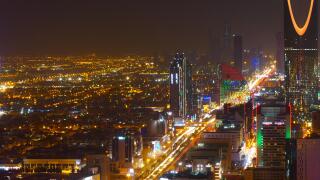 Panorama view to the skyline of Riyadh by night, with the Kingdom centre in the background and yellow lighting, the capital of Saudi Arabia
