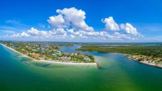 Aerial view of southern Naples FL at Gordon Pass overlooking Port Royal luxury real estate area.