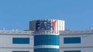 "Ras al Khaimah, Ras al Khaimah/United Arab Emirates - 10/16/2019: "First Abu Dhabi (FAB) Bank blue logo on large building top on a blue sky sunny day