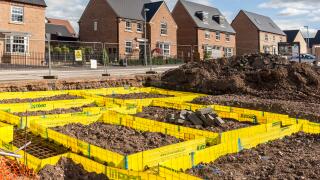 Newbuild houses on new estate with footings marked out for new house, Llanfoist, Abergavenny, UK