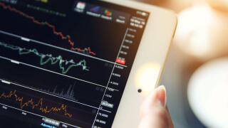 trading online on tablet with bussiness woman hand