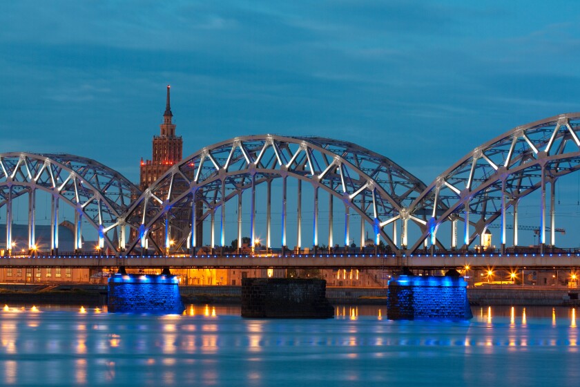 Night river with bridge and reflection in Riga