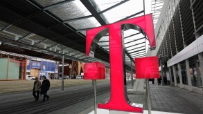 Germany Hanover  2008 - Fairgoers walk past logo of German telecommunications giant Deutsche Telekom at CeBIT Trade Fair