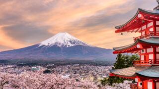 Fujiyoshida, Japan at Chureito Pagoda and Mt. Fuji in the spring with cherry blossoms.