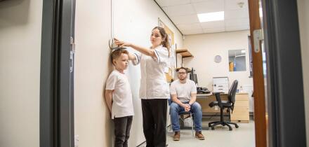Medical professional measuring a child's height
