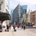 People in Bishopsgate, City of London street scene, looking towards the RBS building, Spitalfields East London UK