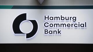 06 July 2021, Hamburg: The logo of Hamburg Commercial Bank can be seen on the bank's branch at Gerhart-Hauptmann-Platz. The Cologne public prosecutor's office searched rooms of the former HSH Nordbank in the course of the Cum-Ex scandal on 06.07.2021. Thi