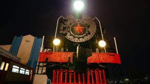 Old black steam locomotive on railway station at night