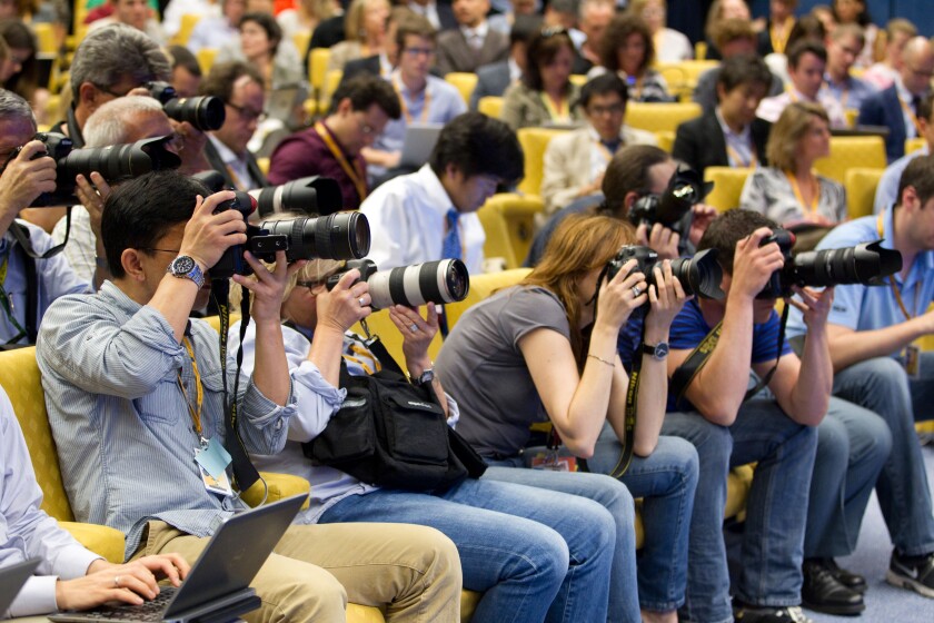 Photographers working in the Press Centre at European Council offices, Justus Lipsius building, Brussels, Belgium.