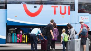 Tui coach driver loading luggage at airport in Spain