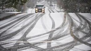 Car on road during snowstorm in Seattle Washington USA. Image shot 2009. Exact date unknown.