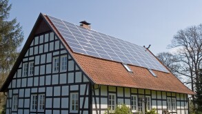 Traditional half-timber framed house with solar panels fitted to the roof, Strohen, Lower Saxony, Germany.