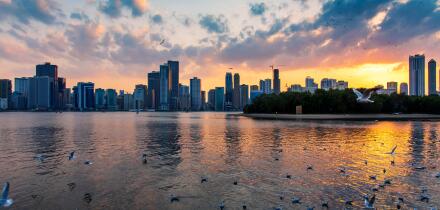 Beautiful sunset over emirate of Sharjah skyline in the Uinted Arab Emirates