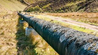 Long water pipe, Medwin Water valley, Scottish Borders, Scotland, UK on sunny Spring day