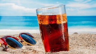A cold drink in a glass on the beach, a delicious soft drink in the summer