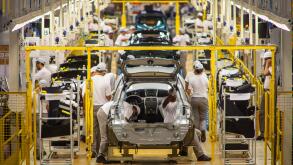Automobile industry blue collar workers - Assembly line at Nissan Resende factory in Brazil.
