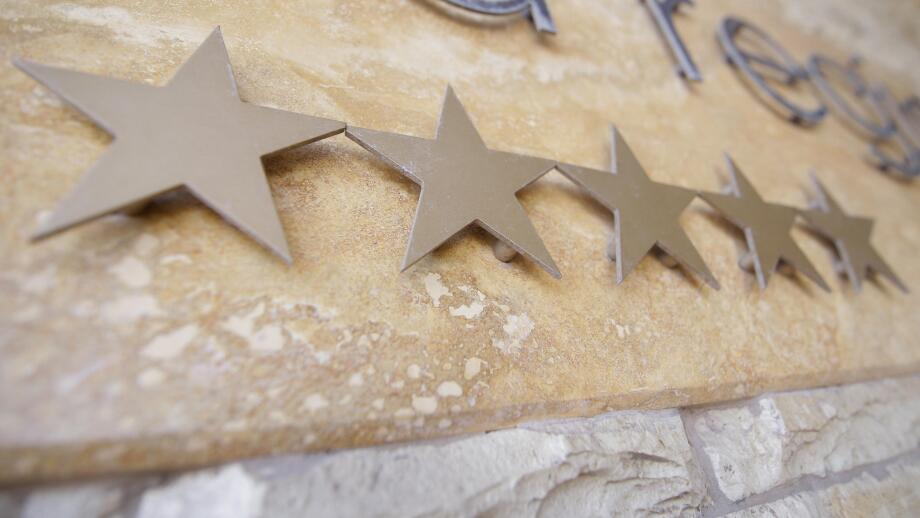 Five stars on a hotel logo at the entrance