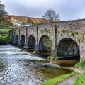 Six arched bridge over the River Barle as it flows through the village of Withypool in Exmoor National Park Somerset UK