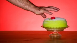 Human hand reaching to take dessert, close-up
