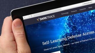 A man looking at the website for Darktrace a cyber-security developer on his iPad. (Editorial Use Only)