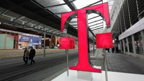 Germany Hanover  2008 - Fairgoers walk past logo of German telecommunications giant Deutsche Telekom at CeBIT Trade Fair