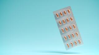 Pills of the drug Molnupiravir in a blister package. Molnupiravir was developed by Merck & Co and is an antiviral Covid-19 therapy. Selective focus