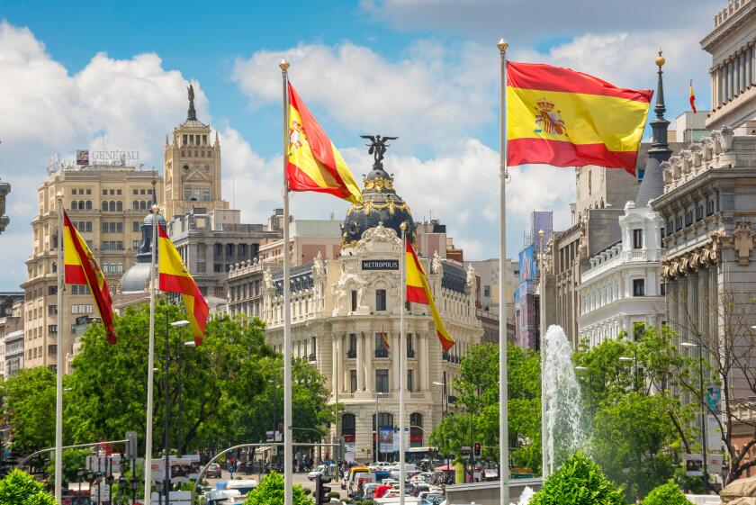 Madrid city center, view along the Calle de Alcala towards the Metropolis Hotel and surrounding architecture in the historic centre of Madrid, Spain.