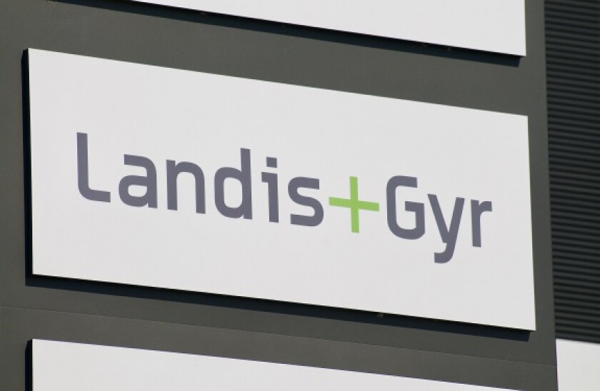 Zug, Switzerland - 28th March 2021 : Landis + Gyr signage hanging in front of the Headquarters building in Zug. Landis + Gyr is is a publicly listed,