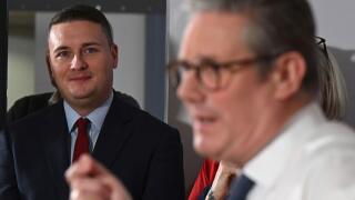 Britain's Health Secretary Wes Streeting, left, watches as Britain's Prime Minister Keir Starmer gives a speech on reducing NHS wait times as he visits a healthcare provider in Surrey, England, Monday, Jan. 6, 2025, (Leon Neal/Pool Photo via AP)