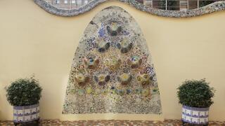 Trencadis mosaic flowerbed in the courtyard garden in the Casa Batllo in Barcelona, Catalonia, Spain. The mansion designed by Catalan modernist architect Antoni Gaudi for the Batllo family as a revenue house as well as a private family residence built was