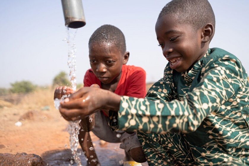 African boys clean water infrastructure from Alamy 9Mar23 575x375