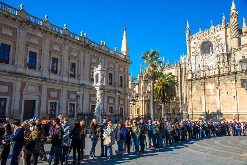 tourists waiting in line for entrance of Real Alcazar, palace in Sevilla, Spain