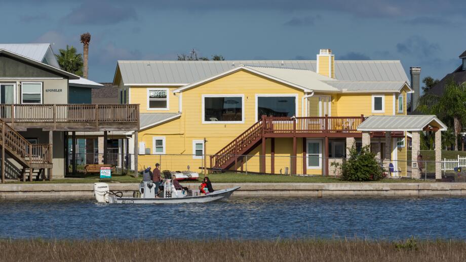 Residential houses encroaching coastal wetlands. Aransas National Wildlife Refuge, Texas, USA.