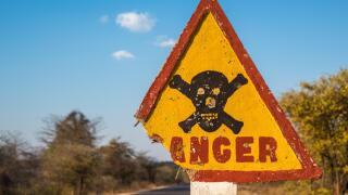 Danger road sign with skull and crossbones