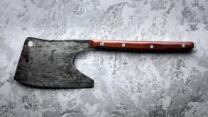 Old rustic axe for meat on grunge background