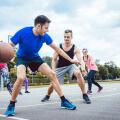 Group of friends are playing basketball outdoors