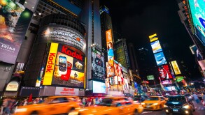 Traffic in Times Square at night with taxi cabs driving through the streets, New York City