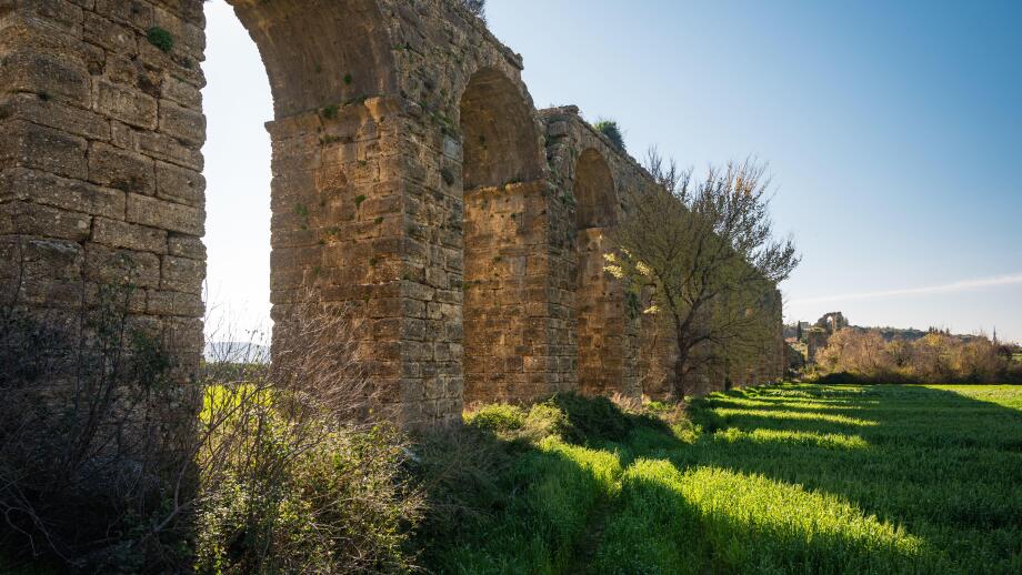 Ancient Roman aqueduct ruins of Aspendos in green spring landscape