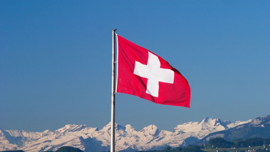 Swiss flag and Alps