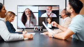 Staying connected with colleagues around the world. a diverse group of businesspeople sitting in the boardroom during a meeting with their international colleagues via video chat.