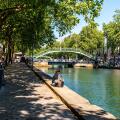 Paris, France, 04.28.2025 People enjoying a warm day on the banks of Canal Saint Martin in the 10th arrondissement of Paris