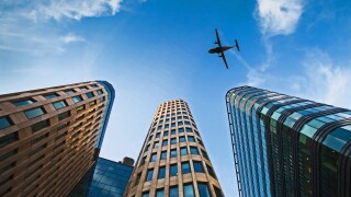 plane over office buildings