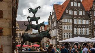 Bremen, Germany - July 16, 2022 : many tourist taking a photo at statue of Town Musicians of Bremen