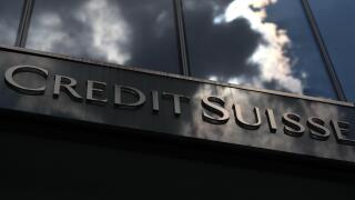 A cloud is mirrored in the facade of the Credit Suisse bank in Frankfurt July 14, 2010. Prosecutors are searching Credit Suisse offices in 13 German cities after evaluating a compact disc with names of alleged tax evaders, prosecutors in Duesseldorf, Germ