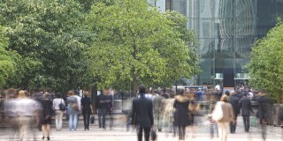 Business people walking in a financial district commuters trees green.jpg