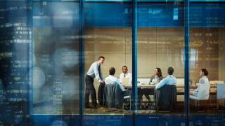 Corporate business people meeting in highrise conference room