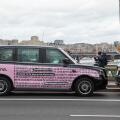 Black taxis with pink Klarna poster in Westminster London, UK