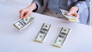 Distribution of funds. Female hands lay money