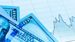 Currency market concept paper chart graph. Toned in blue